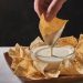 dipping chip in queso