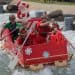 crew racing homemade boat on water channel