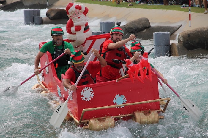 crew racing homemade boat on water channel