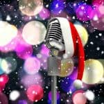 Microphone with santa hat in front of colorful lights