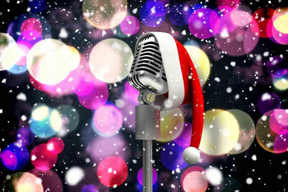 Microphone with santa hat in front of colorful lights