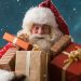 happy santa holding wrapped presents in snowfall