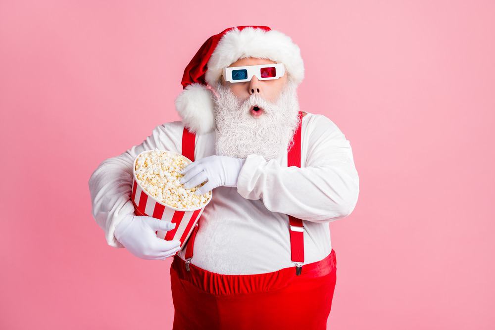 Santa wearing 3D glasses and eating popcorn