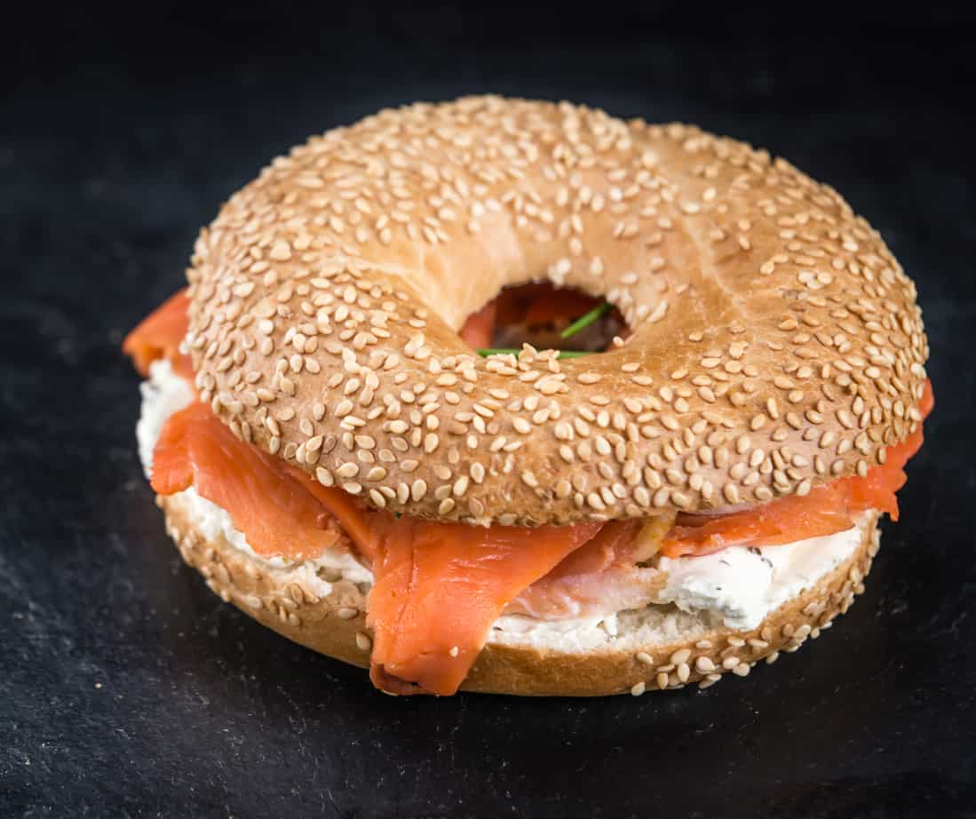 sesame seed bagel with cream cheese and smoked salmon / lox