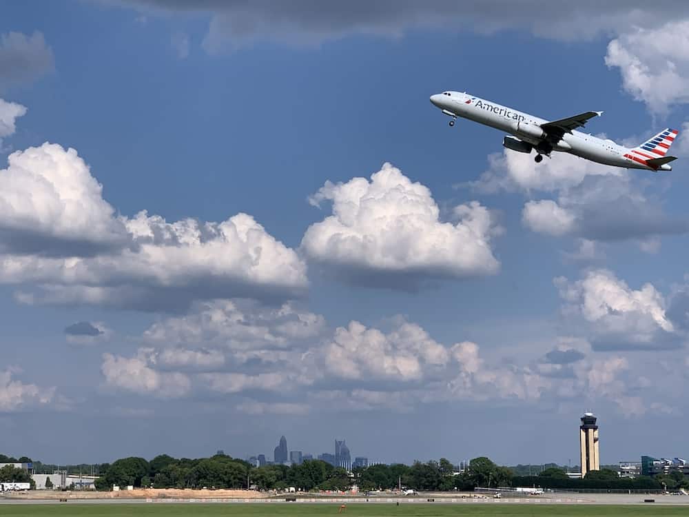 Plane taking off with Charlotte skyline in distance