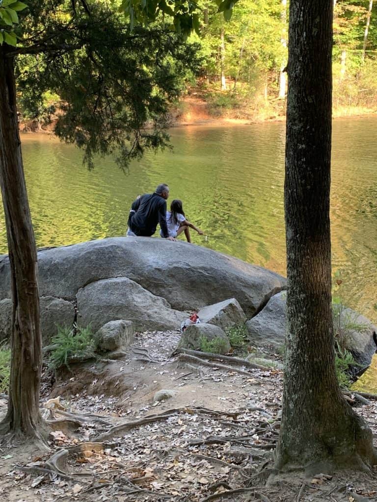Man and child on big rock