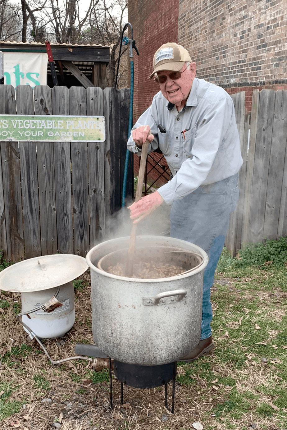 Silas Davis boiling peanuts in front of Davis General Store
