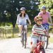 Family riding bikes on a path