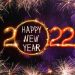 Bright text Happy New 2022 Year made of firework on dark background. Greeting card design