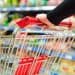 Closeup of hands pushing grocery cart at the supermarket