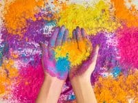 Hands holding colored powder for Holi celebration