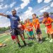 football coach instructing children