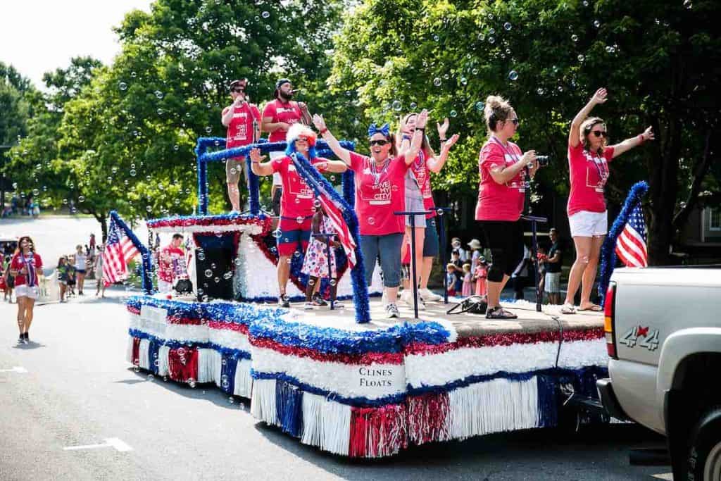 participants on floats at Baxter Village's 4th of July parade