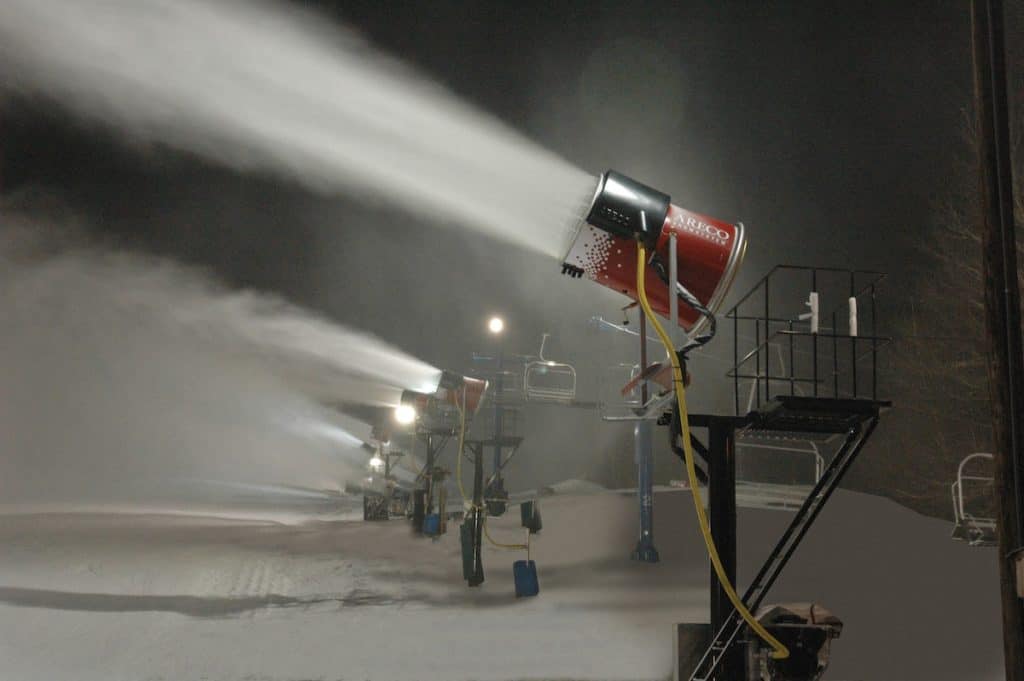 snowmaking machine making snow at night