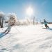 Two Women Skiing Down Beech Mountain Slope with Snowy Trees in Background