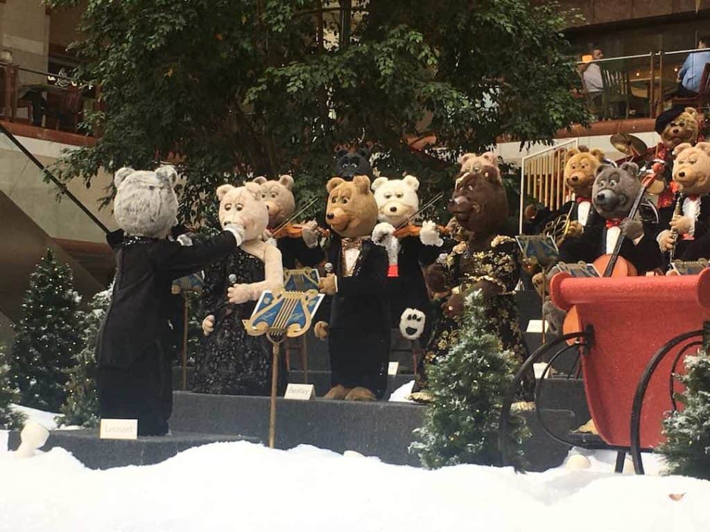 Animatronic bears in formal wear performing in an orchestra