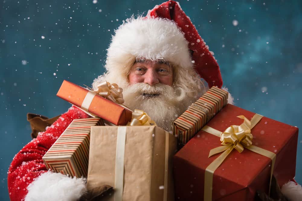 Santa holding lots of presents