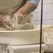 close-up of hands shaping clay on a pottery wheel at Makerspace Charlotte