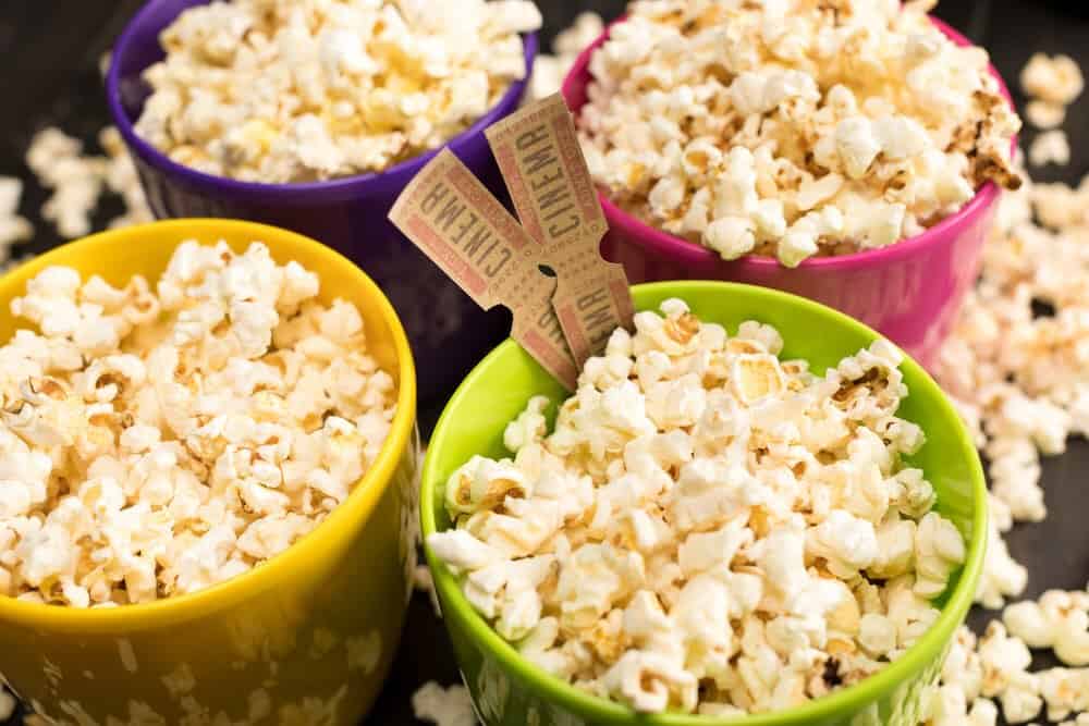 several buckets of popcorn and a couple movie tickets