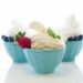 Cups of soft-serve frozen yogurt on white background.