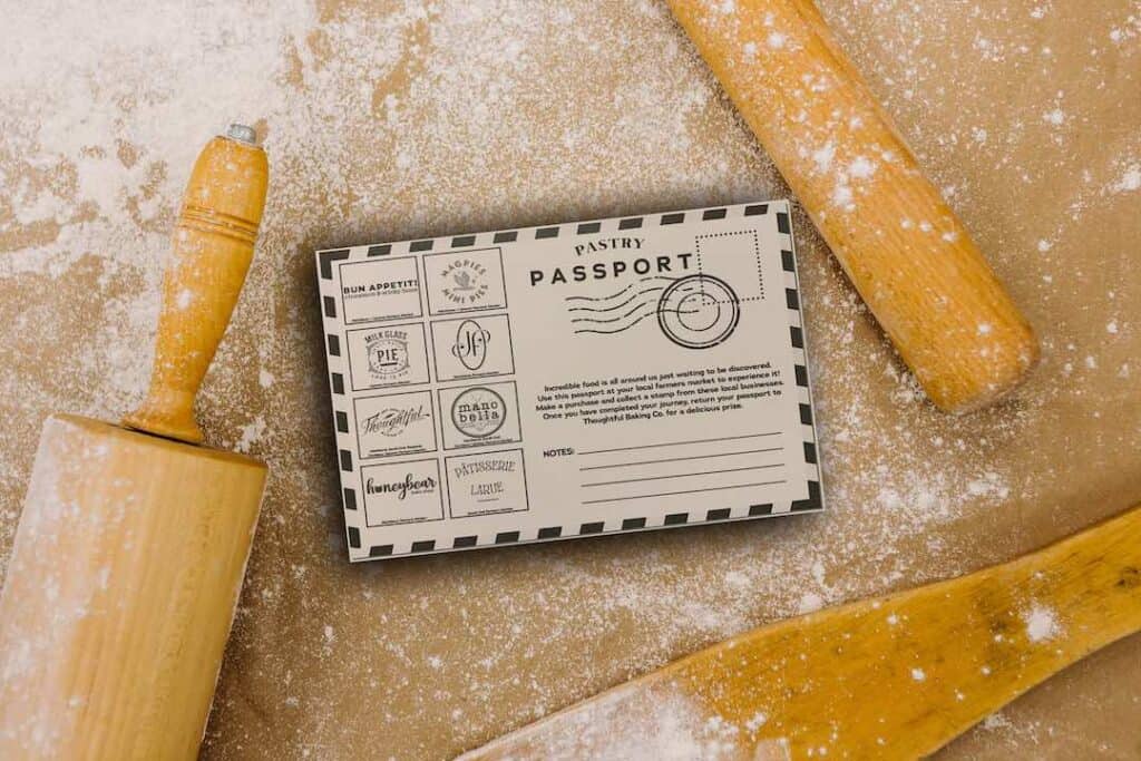Floured cover counter, with rolling pins. A pastry passport with logos from different bakeries