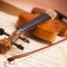 Violin and bow lying on sheet music