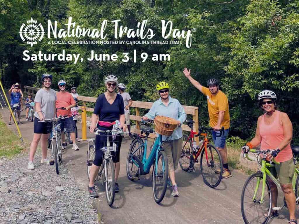 Group of bike riders, with bridge in the background and the words National Traild Day Saturday, June 3