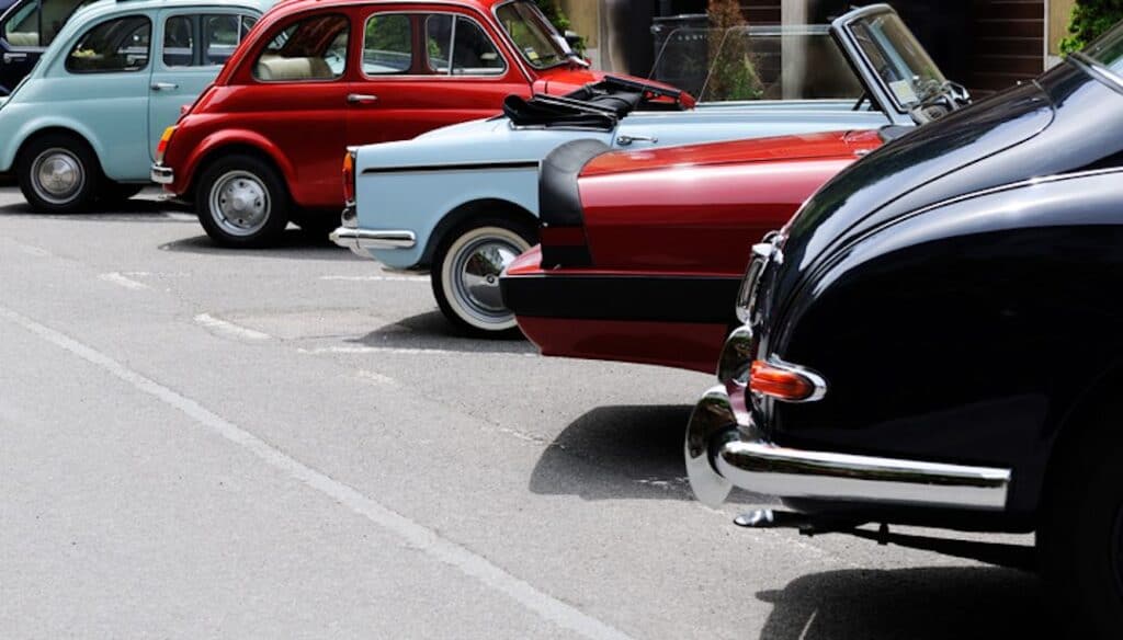 Several vintage cars at a car show