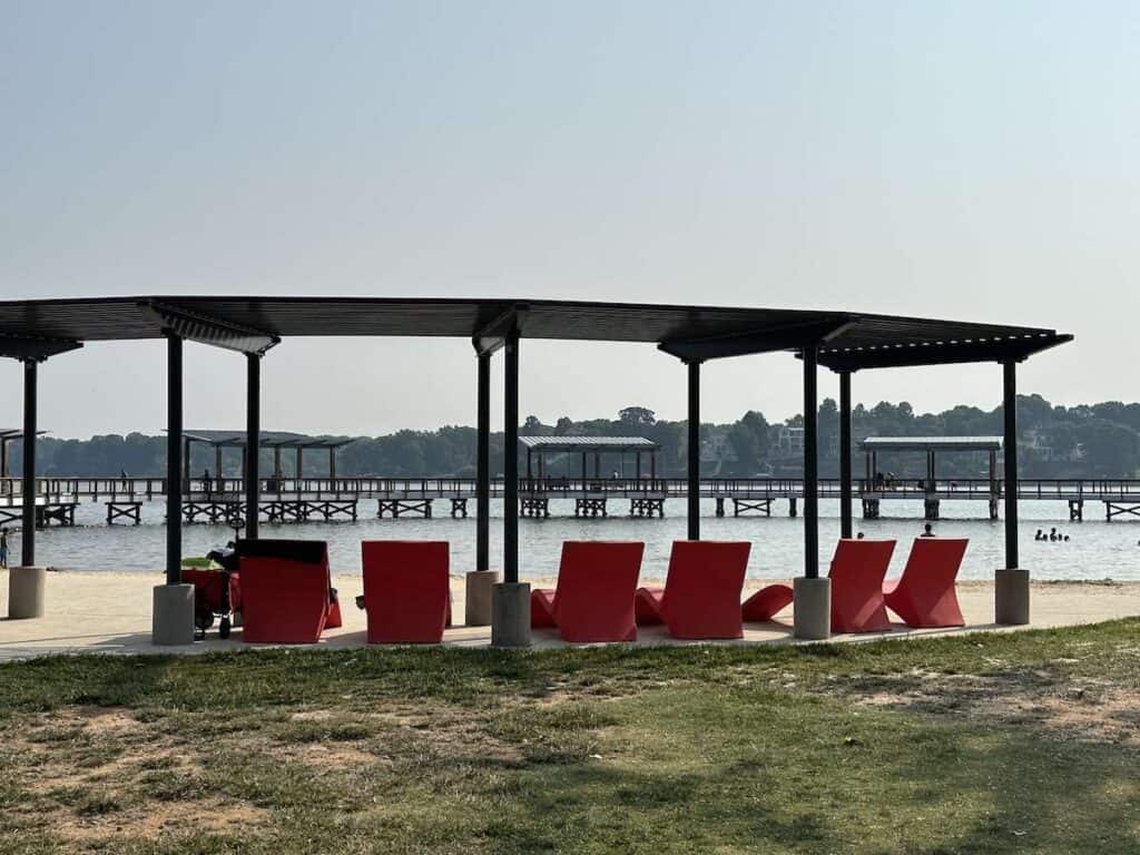 shaded seating area with red lounge chairs at ebenezer park in rock hill, SC