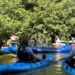 band floating down a river with people kayaking