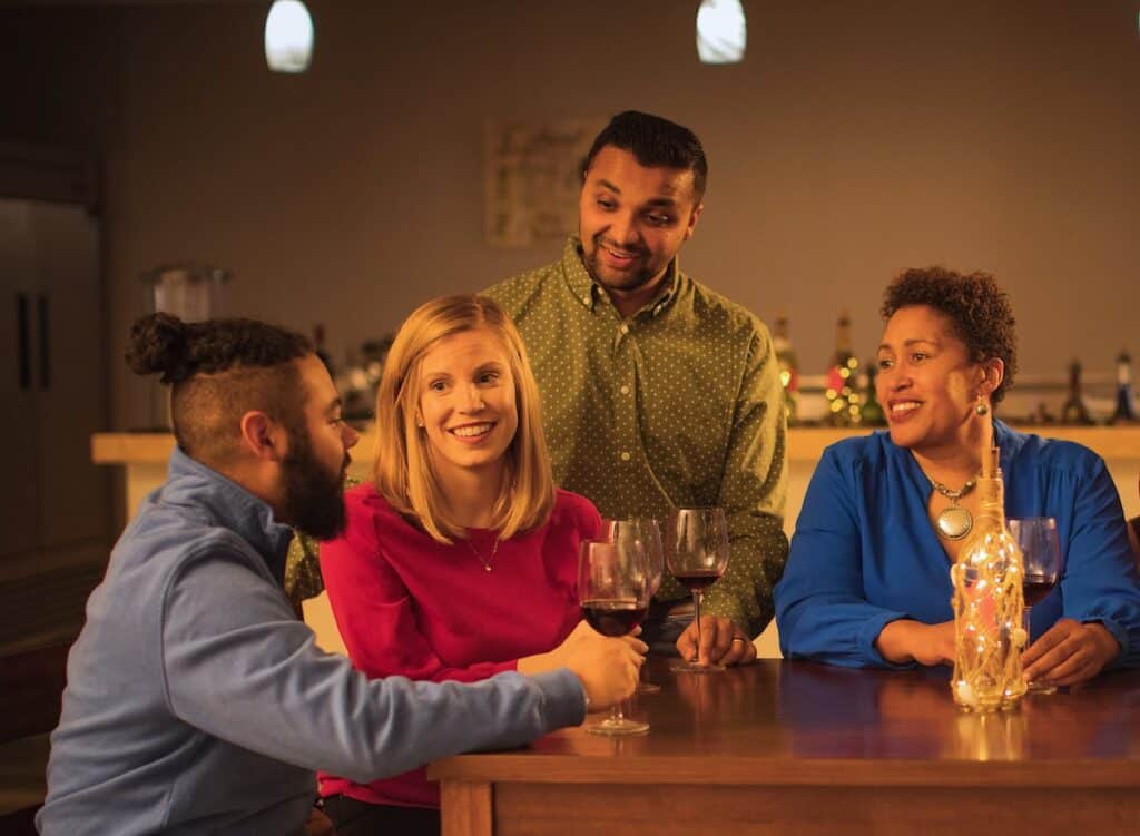 Four people enjoying wine at a table