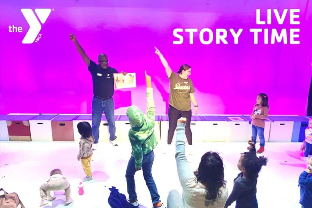adults performing and reading stories to children