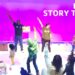 adults performing and reading stories to children