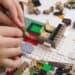 close-up of child putting together LEGOs