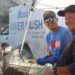 Two men cooking liver mush at festival
