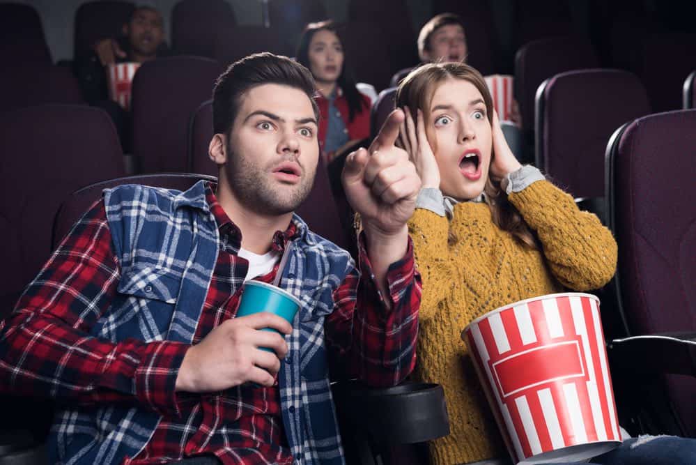 scared couple in movie theater