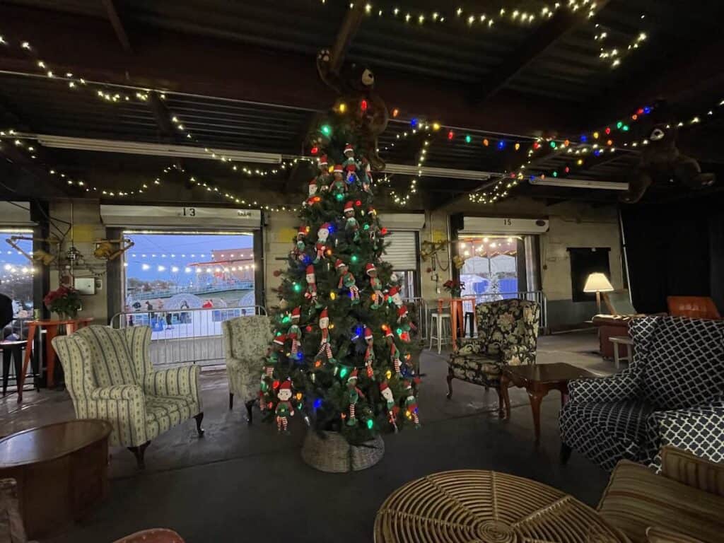 Upholstered chairs surrounding Christmas tree