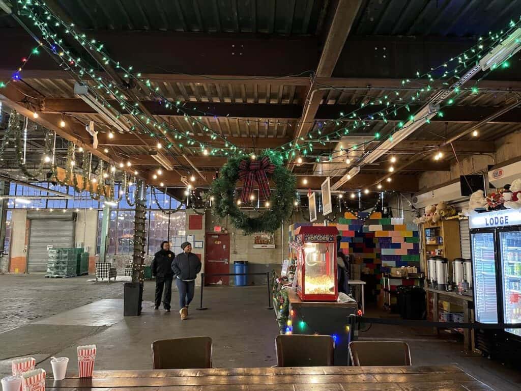 Wreath in foreground popcorn and hot drinks indoors at Lodge