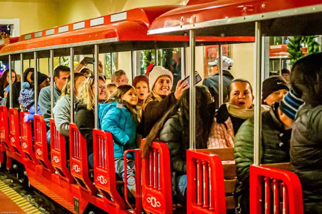 Families on red Winterland Express train at Kannapolis' Celebration of Lights