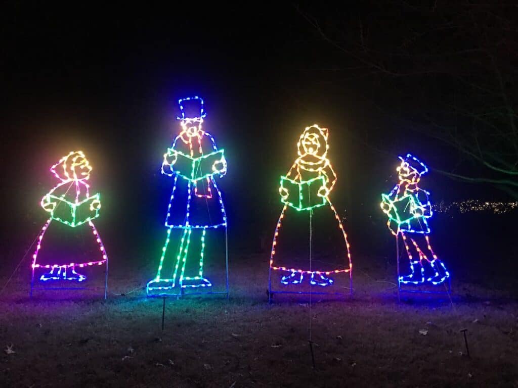 Christmas light display depicting carolers