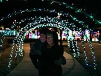 couple under arch of lights at City of Kings Mountain's Christmas Light Extravaganza