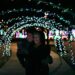 couple under arch of lights at City of Kings Mountain's Christmas Light Extravaganza