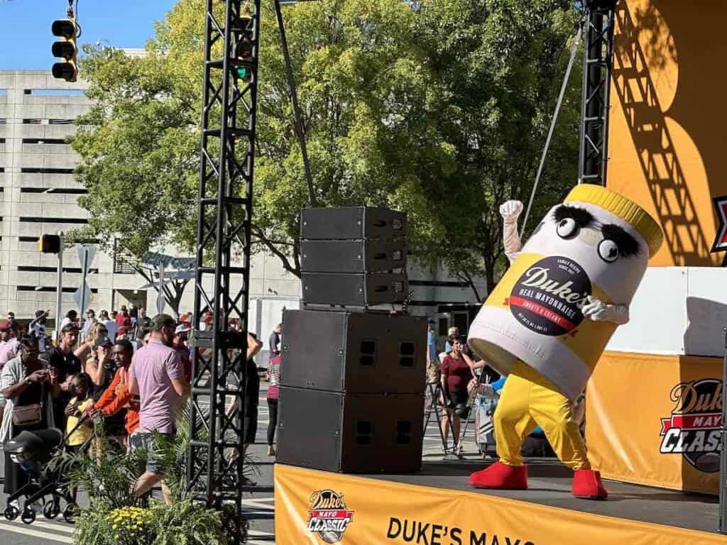 Duke's Mayo mascot dancing on stage