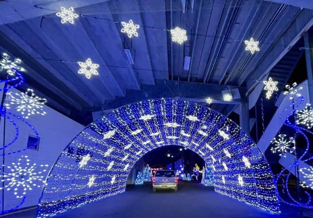 car going through blue lighted tunnel at Speedway Christmas
