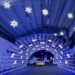 car going through blue lighted tunnel at Speedway Christmas