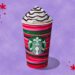 Starbucks cup with hot chocolate and whipped cream