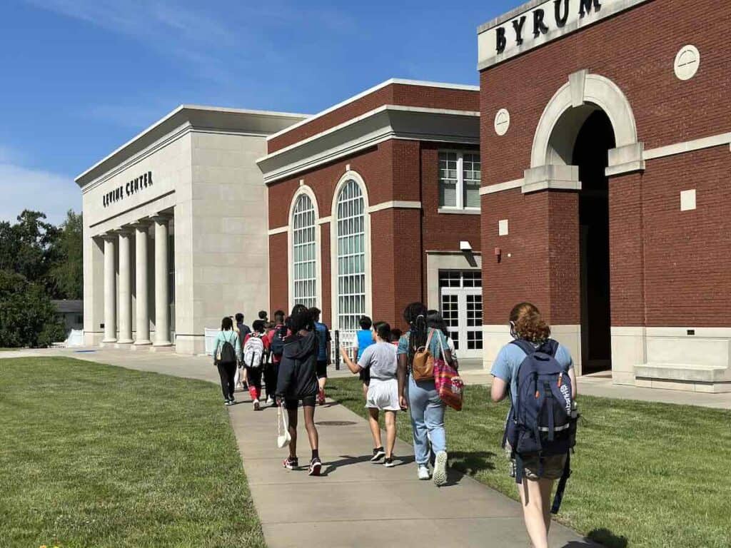 students walking on campus of Queens University campus