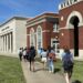 students walking on campus of Queens University campus