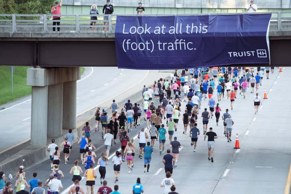 Runners in 10K running under a bridge