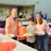 Family holding plates of pancakes
